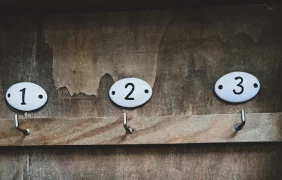 Numbers over Hooks on Wooden Wall